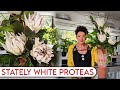 Stately white proteas with a few sprigs of salal foliage | Floristry Design Tutorial