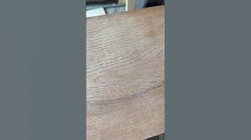 How does the wood grain embossing machine press patterns on plywood