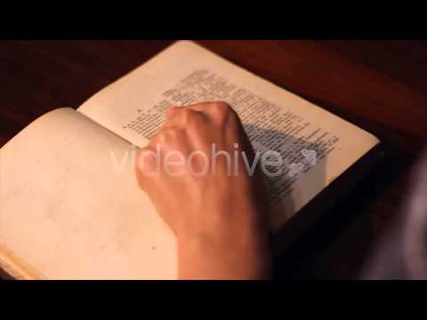 Girl Opens An Old Dictionary