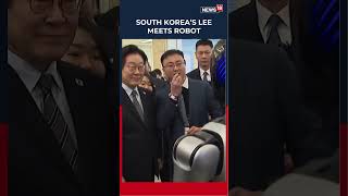 South Korea’s Lee Shares A Handshake With A Humanoid Robot During A Visit In Shanghai | N18S