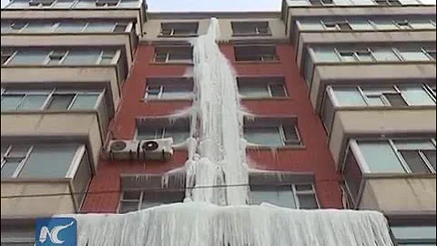 Icefall forms outside 7-floor building