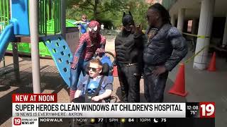 Superheroes wash windows at Akron Children's