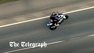 Watch: Motorcyclist pulls wheelies in dramatic high-speed police chase