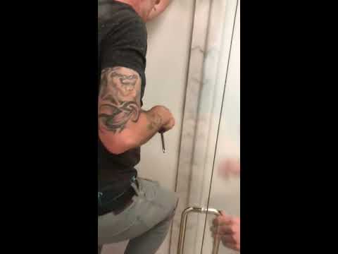 How to adjust sagging frameless door that’s hitting glass panel.