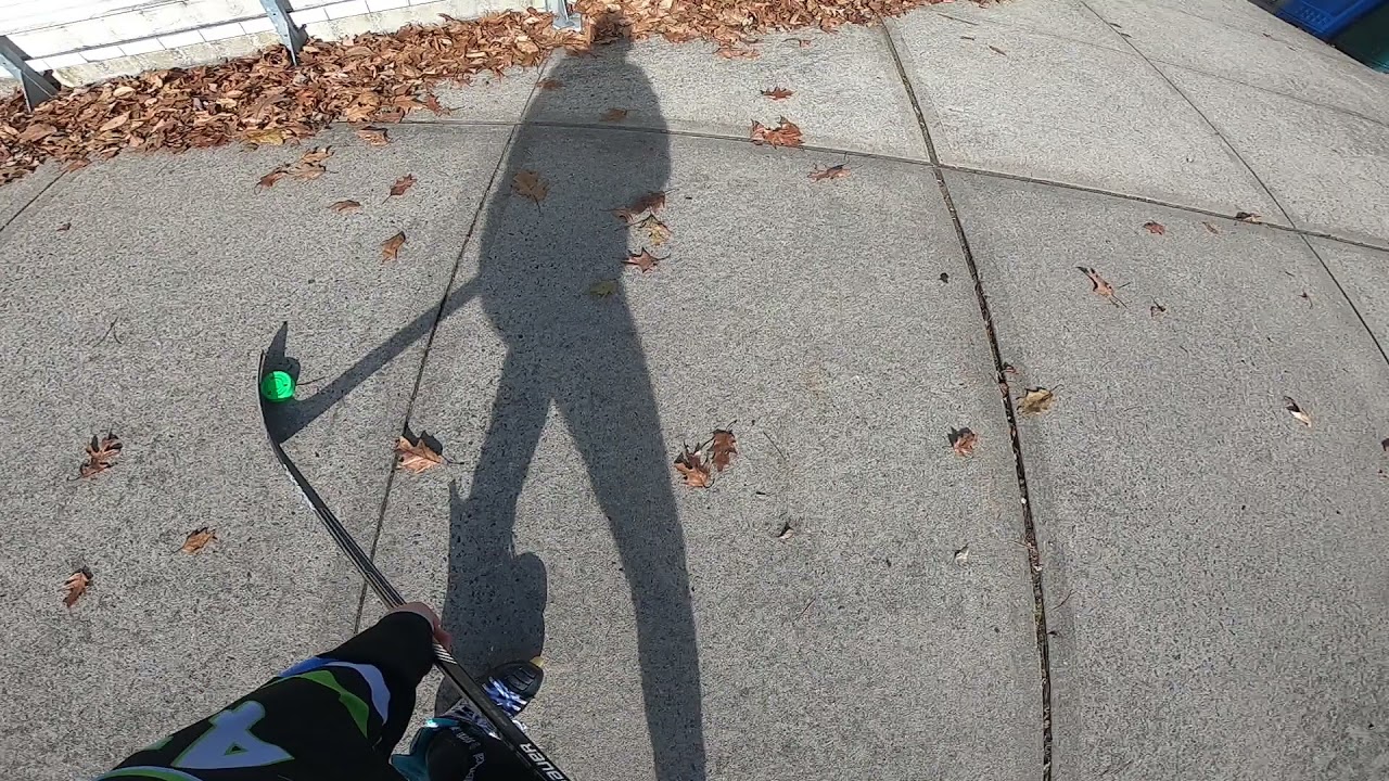 Green Biscuit Hockey Puck Stick Handling Practice on Rough Asphalt