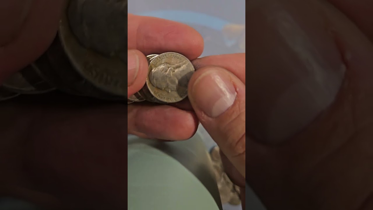Let's find some real treasure! Thumbing through nickels looking for silver and coins. Silver found!