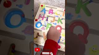 Alphabet from A to Z on a wooden board with magnetic balls