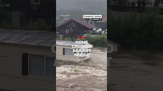 Home crushed against bridge