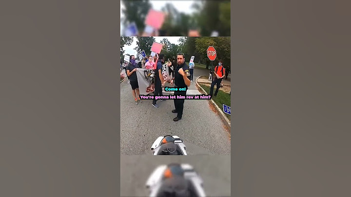 Protesters try to stop biker in the middle of the road 😱