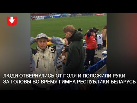 Люди отвернулись от поля и положили руки за головы во время гимна перед матчем «Крумкачы» - «Ислочь»