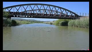 Passing under a railway bridge and coming out the other side on the River Arun.