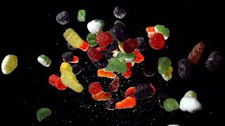 Cinematic Slow Motion Of Floating Gummy Candies And Sugar Particles
