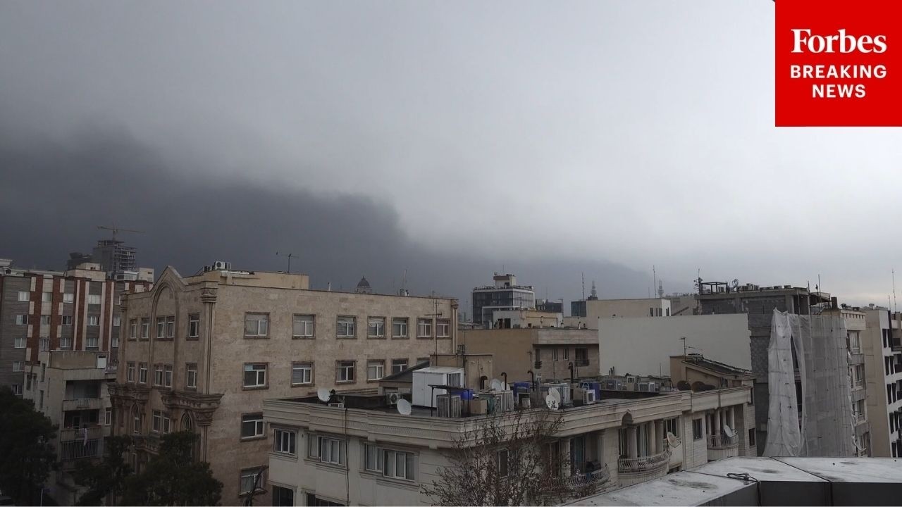 Black, oily rain falls over tehran following u. S. -israeli strikes on oil facility in iran
