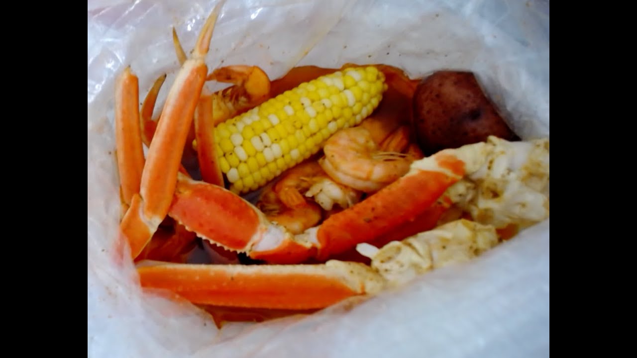 Eating A Seafood Boil With Snow Crab Legs And Shrimp In A Mild, Butter