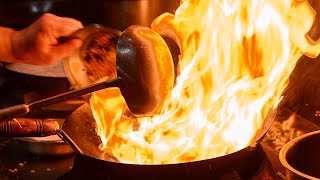 炎の料理人自由自在に中華鍋を操る達人の技。