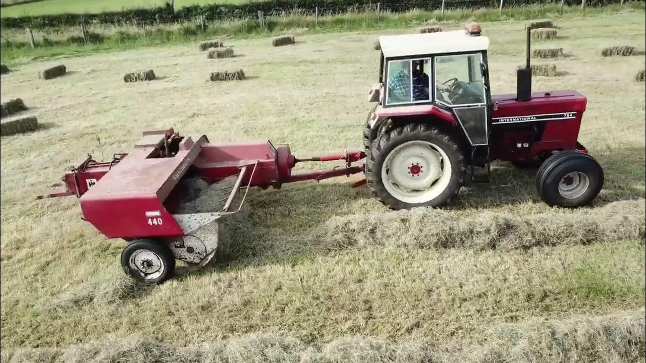 International 784 & International 440 baler assisted by a Ford 2000