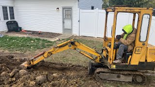 Excavator digging a French drain