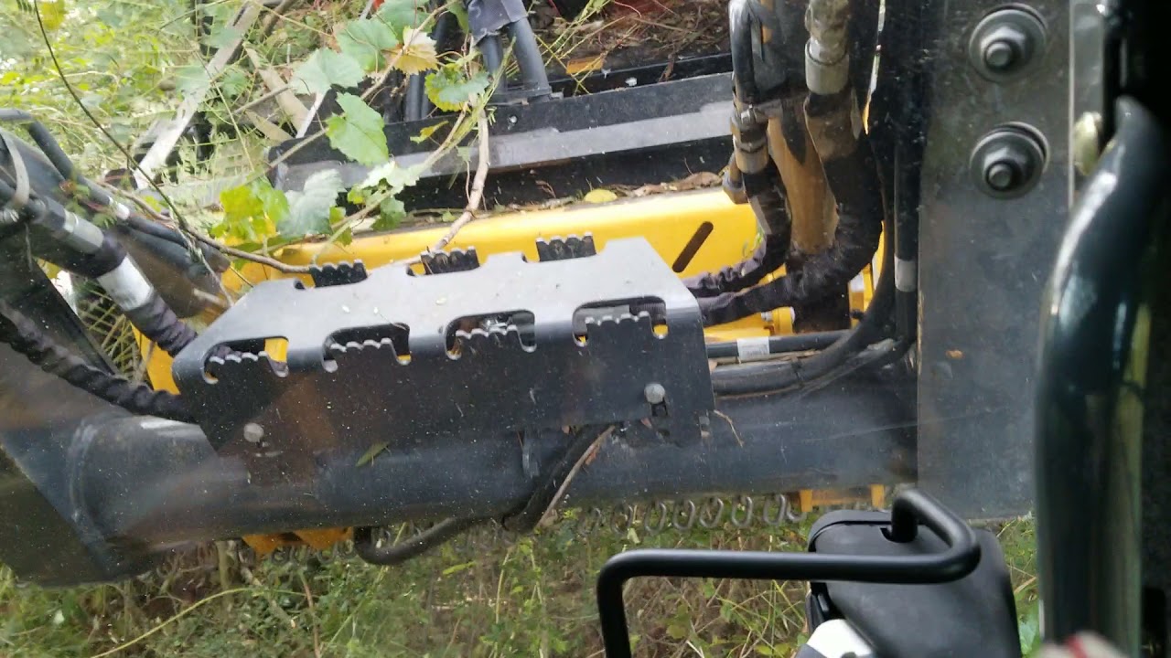 John Deere 325G brush cutting with a Skid Pro industrial brush cutter