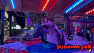 A Brave Girl In A Dress Riding On A Mechanical Bull In Benidorm