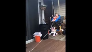 Dad Swinging His Little Girl Using A Rope Attached To The Swing