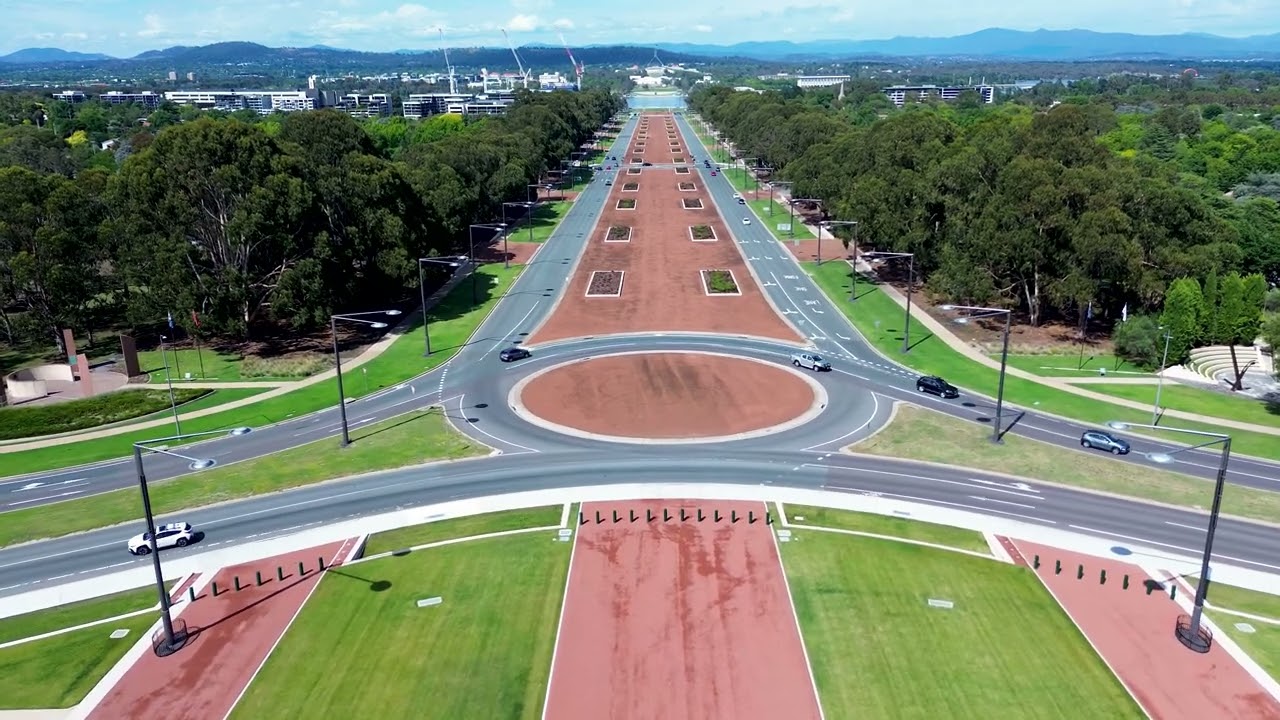 Drone aerial landscape of cars travelling roundabout on road of Anzac Parade Canberra ACT Australia