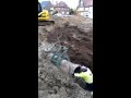 Kobelco 235 laying concrete sewer pipes