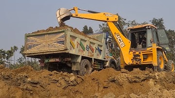 Jcb loader backhoe machine collecting  soil and loading into heavy truck @jcbplanetroad