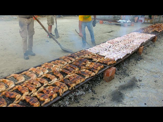 Tons of Chicken Roasted and Cooked in a Huge and Long grill. Italian Street Food