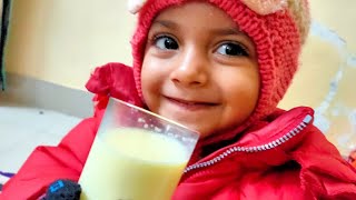 baby drinking milk from glass