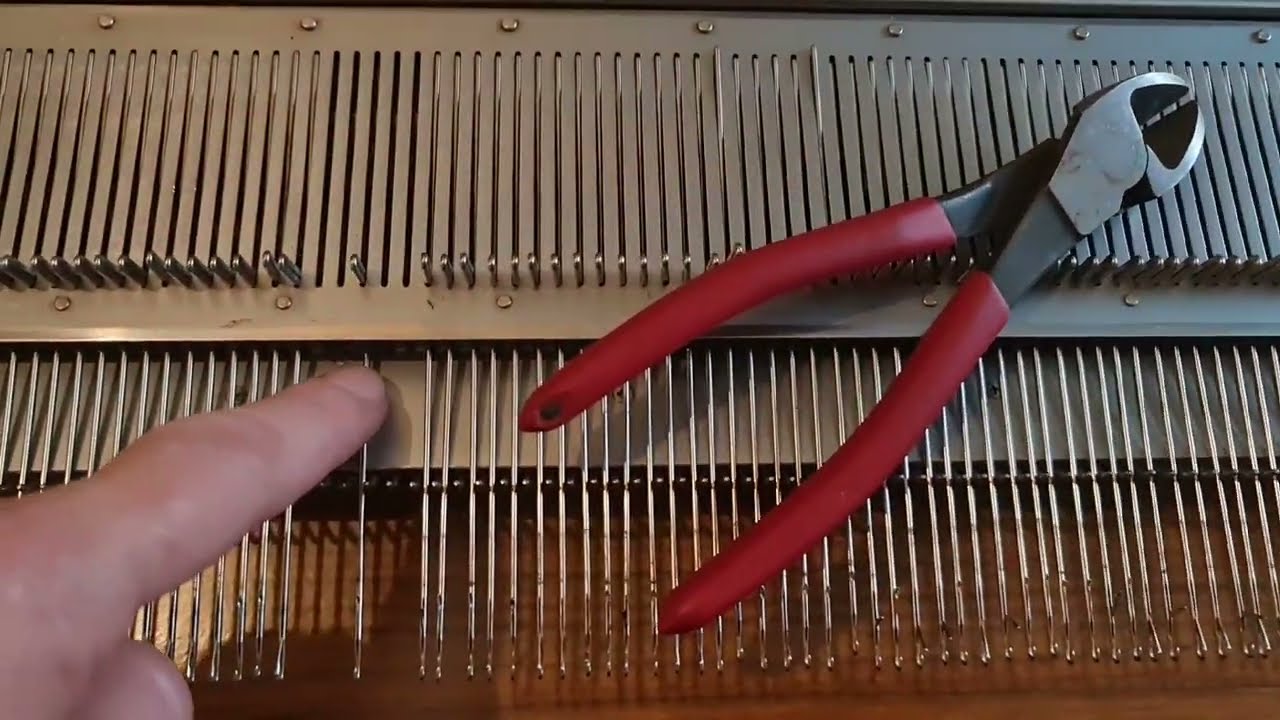 Removing a totally stuck needle from a knitting machine bed.. cutting it out