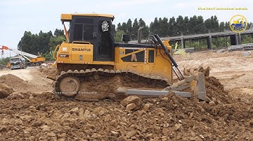 SHANTUI DH17C2 Bulldozer pushing soil & 24 ton dump trucks unloading soil filling up