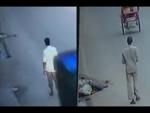Sickening Footage Of Hit And Run Victim Being Robbed While Left To Die By Passersby 