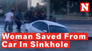 Watch: Firefighters Save Woman Stuck In Car Swallowed By Sinkhole