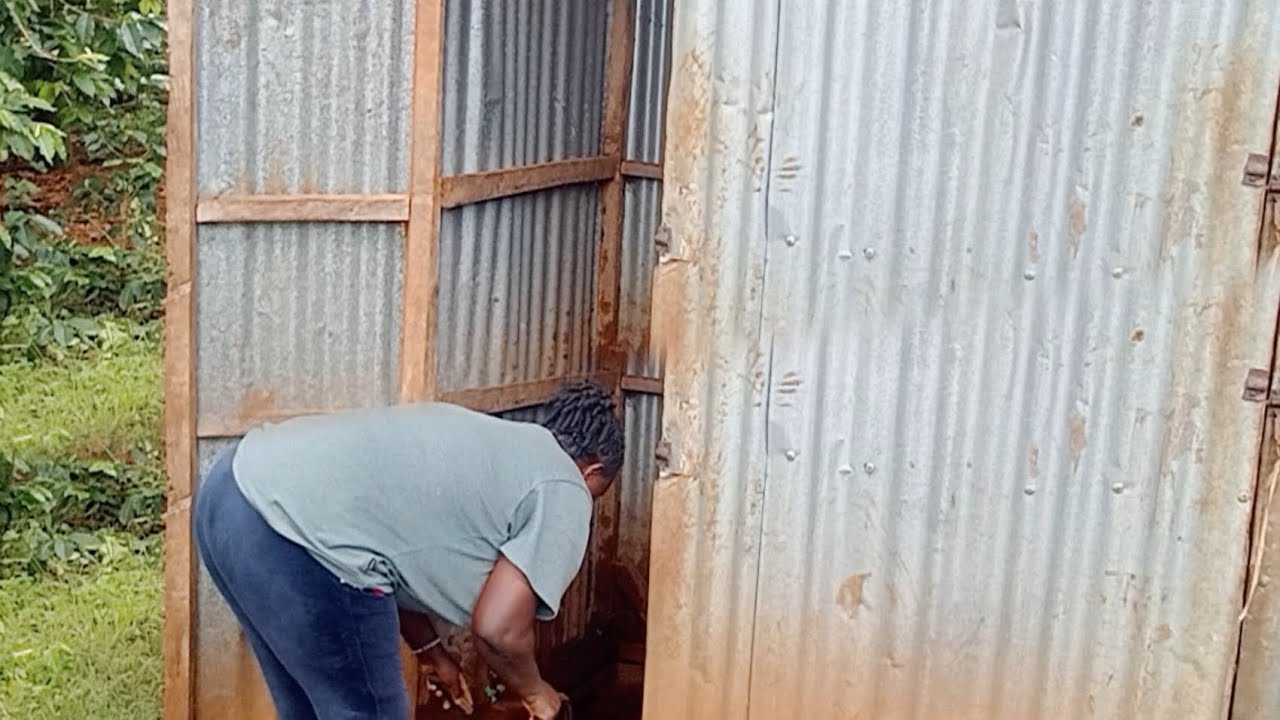 African mum washing village toilet 