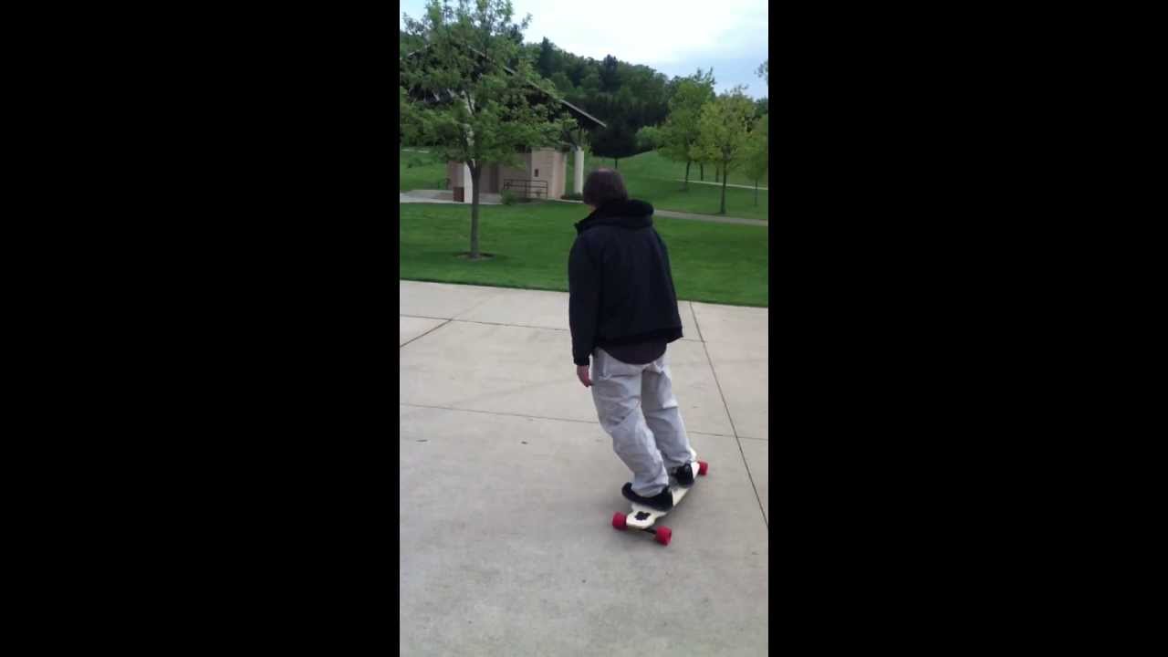 Old man almost falls on longboard