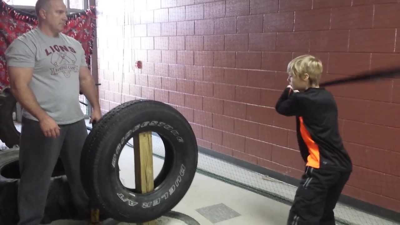 10 year old demonstrates 36 oz. heavy bat swings on tire ...