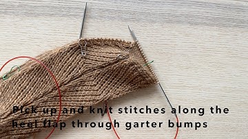 Pick up and knit stitches along the heel flap through garter bumps