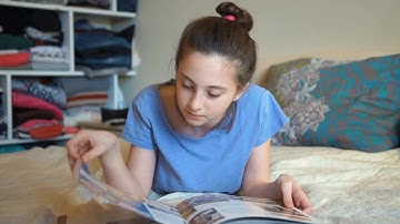 Young Girl Browsing A Book Stock Video