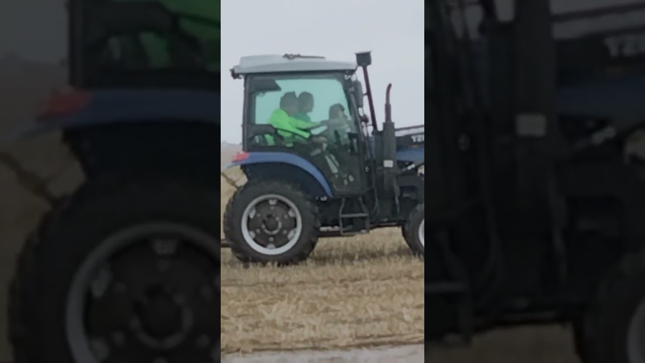 Little girl's mom driving a tractor in a first time in the farm 