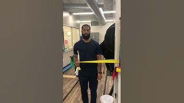 Standing shoulder external rotation with theraband