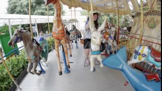 Girl rides on the carousel
