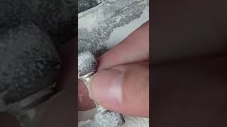 This is the process of grinding a pearl ornament using a tool in the factory.#tools