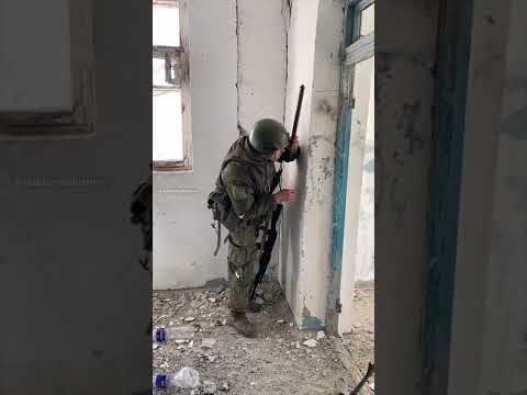 Russian soldier using a hand-held periscope at the Azovstal plant in Mariupol