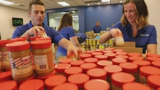 Volunteers pack 1,000 bags of food to help the United Food Bank
