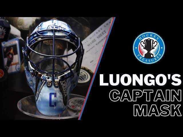 Goalie Roberto Luongo of the Vancouver Canucks gets his helmet