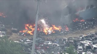 Sky5 over explosions, roof collapse during junkyard fire