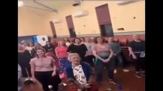 A bunch of women choir singing Creep by Radiohead except its pitched up and in low quality