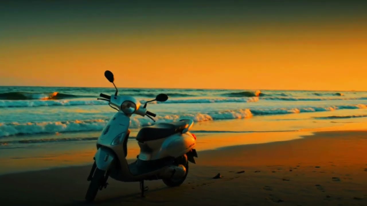Scooter parked by the ocean during a beautiful golden sunset by 2WheelTrip offering trusted and affordable rentals across Shrivardhan Harihareshwar and Diveagar at best rates 8767071784