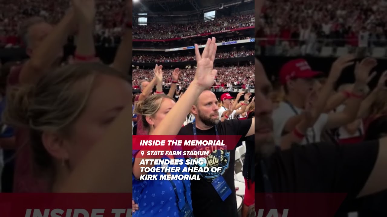 Attendees Sing Together At The Charlie Kirk Memorial