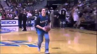 Fan makes a basketball dunk while he's on the phone